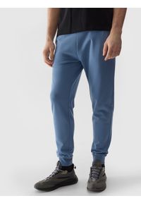 4f - Spodnie dresowe joggery męskie - denim. Kolor: niebieski. Materiał: dresówka, denim. Wzór: gładki, jednolity, ze splotem