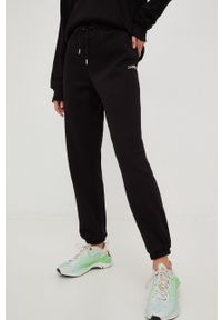 DKNY - Dkny spodnie dresowe damskie kolor czarny gładkie. Kolor: czarny. Materiał: dresówka. Wzór: gładki