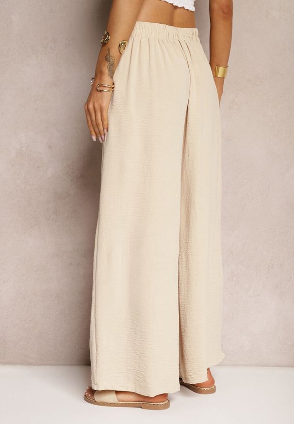 Renee - Beżowe Spodnie w Stylu Alladynek High Waist Wykończone Gumką w Pasie Riselma. Okazja: na co dzień. Stan: podwyższony. Kolor: beżowy. Styl: casual, sportowy