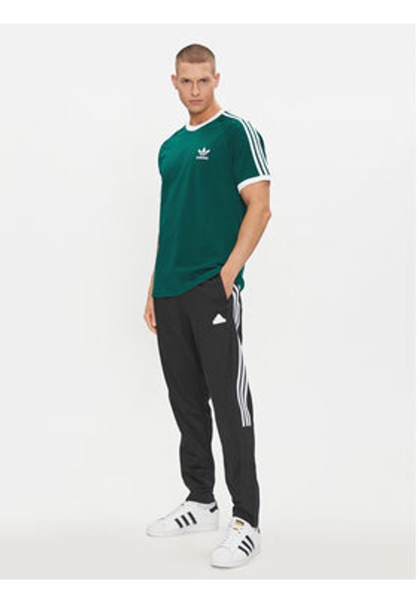 Adidas - adidas Spodnie dresowe Tiro IP3778 Czarny Regular Fit. Kolor: czarny. Materiał: bawełna