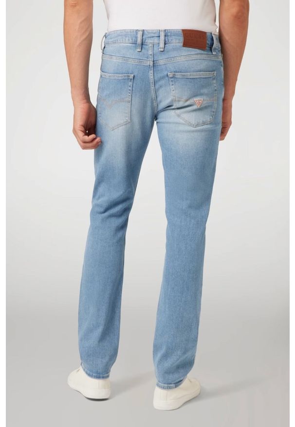 Guess - GUESS Błękitne męskie spodnie jeansowe Angels. Kolor: niebieski