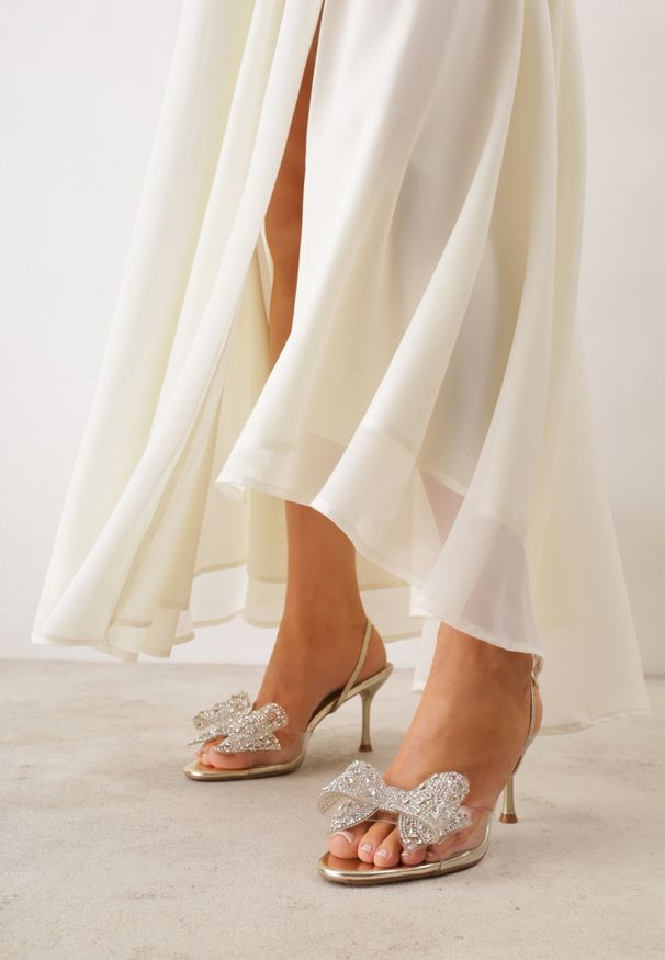 Born2be - Złote Eleganckie Sandały Transparentne VICES na Szpilce z Kokardą z Cyrkoniami Pirera. Okazja: na komunię, na wesele, na studniówkę, na ślub cywilny. Zapięcie: pasek. Kolor: złoty. Obcas: na szpilce. Styl: elegancki