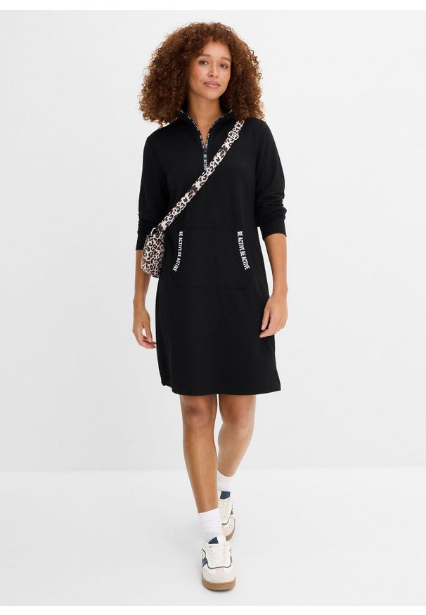 bonprix - Miękka sukienka dresowa. Typ kołnierza: kaptur. Kolor: czarny. Materiał: dresówka. Typ sukienki: sportowe. Styl: sportowy