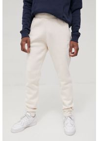 adidas Originals spodnie Adicolor męskie kolor beżowy gładkie. Kolor: beżowy. Materiał: materiał, bawełna, dzianina. Wzór: gładki