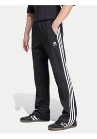 Adidas - adidas Spodnie dresowe adicolor 70's IZ4807 Czarny Regular Fit. Kolor: czarny. Materiał: bawełna