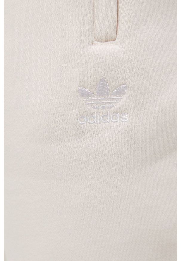 adidas Originals spodnie Adicolor męskie kolor beżowy gładkie. Kolor: beżowy. Materiał: materiał, bawełna, dzianina. Wzór: gładki
