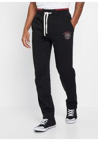 bonprix - Spodnie sportowe z czystej bawełny, ze sportowymi detalami. Kolor: czarny. Materiał: bawełna. Wzór: nadruk. Styl: sportowy #1