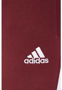 Adidas - adidas spodnie dresowe kolor bordowy z aplikacją. Kolor: czerwony. Materiał: dresówka. Wzór: aplikacja #4