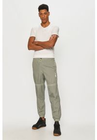 Reebok - Spodnie. Kolor: zielony. Materiał: tkanina #2