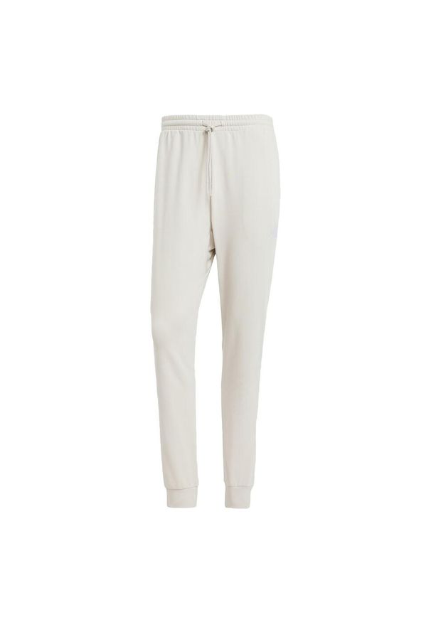 Adidas - Spodnie Essentials Feel Cozy French Terry. Kolor: biały, wielokolorowy, beżowy. Materiał: dresówka, materiał. Sport: fitness