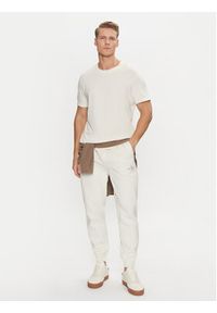 Calvin Klein Jeans Spodnie dresowe Monologo Hwk Pant J30J325658 Écru Regular Fit. Materiał: bawełna, syntetyk