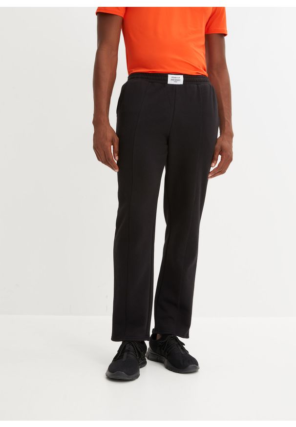 bonprix - Spodnie sportowe ze szwami dzielącymi. Kolor: czarny. Styl: sportowy