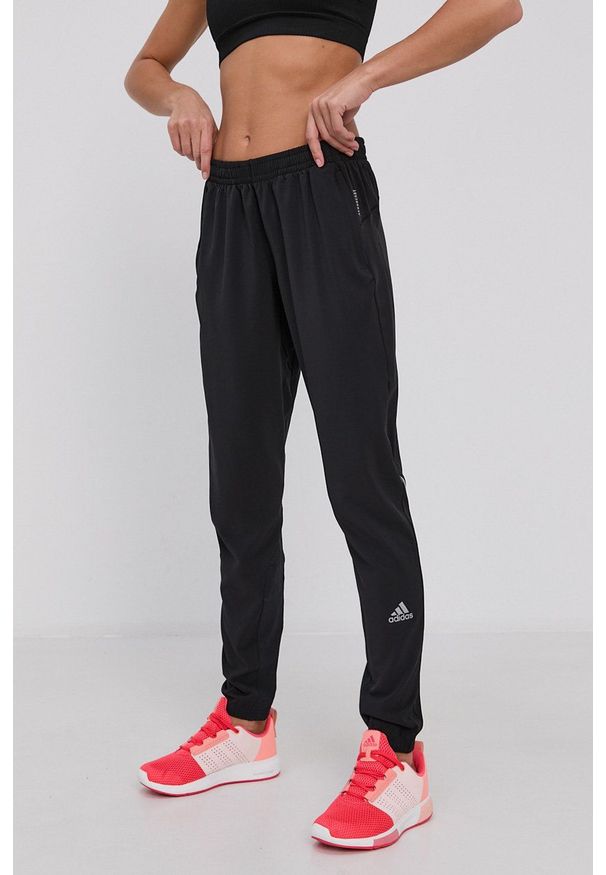 adidas Performance Spodnie damskie kolor czarny z nadrukiem. Kolor: czarny. Materiał: tkanina, materiał. Wzór: nadruk