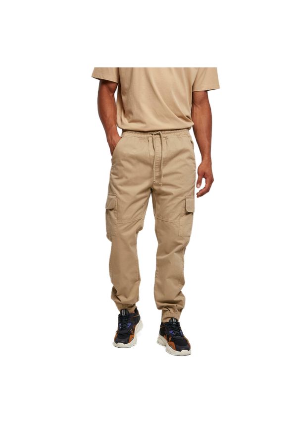 Spodnie do biegania Urban Classics Military. Kolor: beżowy. Długość: długie. Wzór: moro. Sport: bieganie