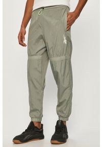 Reebok - Spodnie. Kolor: zielony. Materiał: tkanina #1