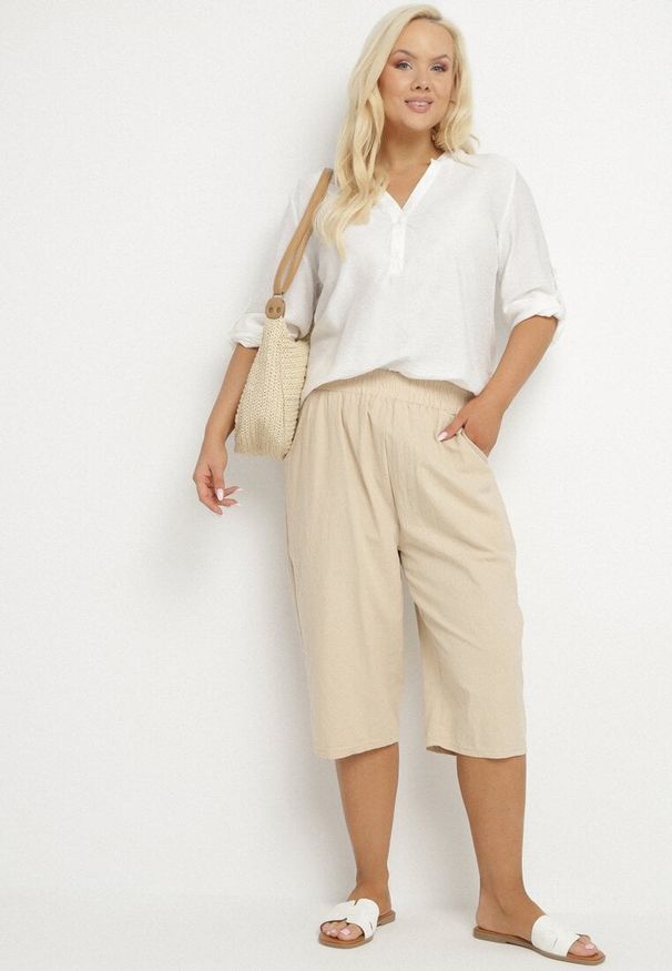 Born2be - Beżowe Luźne Spodnie z Bawełny z Wysokim Stanem 3/4 Lumelle. Okazja: na co dzień. Stan: podwyższony. Kolor: beżowy. Materiał: bawełna. Styl: casual, klasyczny