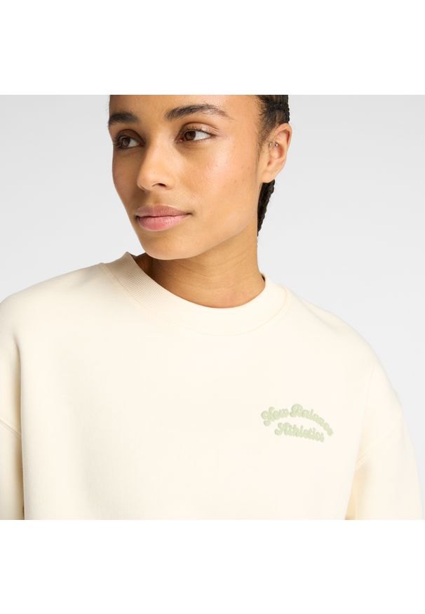 Bluza damska New Balance WT53516PEF – beżowa. Okazja: na co dzień. Kolor: beżowy. Materiał: poliester, prążkowany, bawełna, dresówka, materiał. Wzór: napisy, aplikacja. Styl: casual