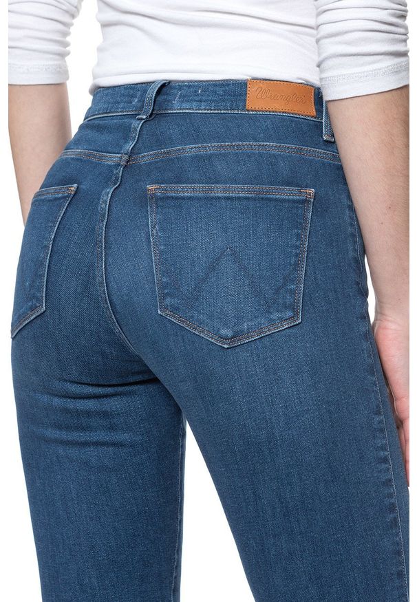 Wrangler - DAMSKIE SPODNIE JEANSOWE WRANGLER HIGH RISE SKINNY MID INDIGO W27HVQX8E 112128135. Okazja: na co dzień. Stan: podwyższony. Styl: casual, elegancki
