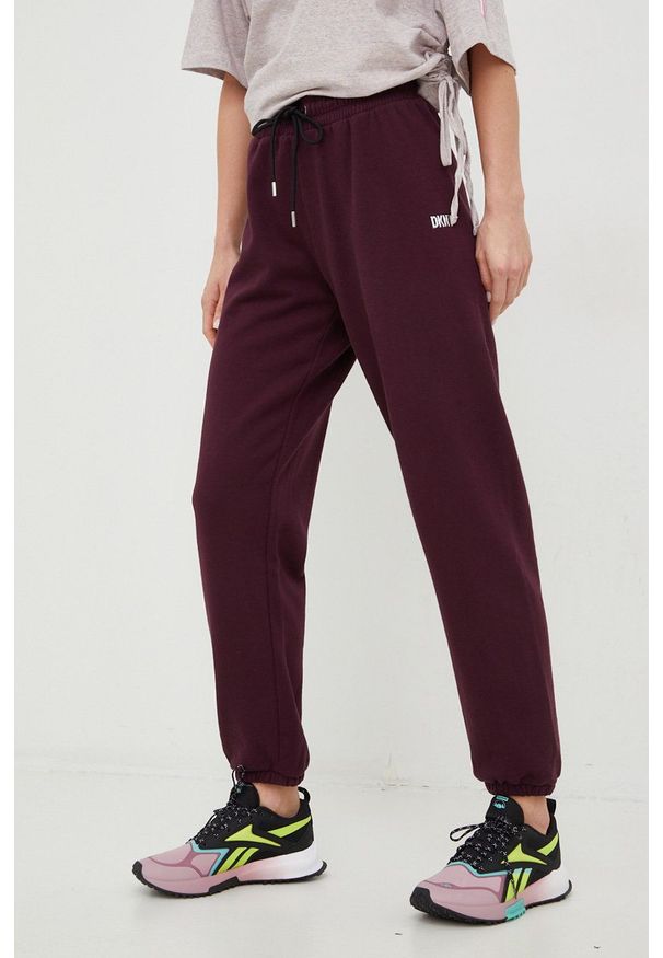 DKNY - Dkny spodnie dresowe damskie kolor fioletowy gładkie. Kolor: fioletowy. Materiał: dresówka. Wzór: gładki