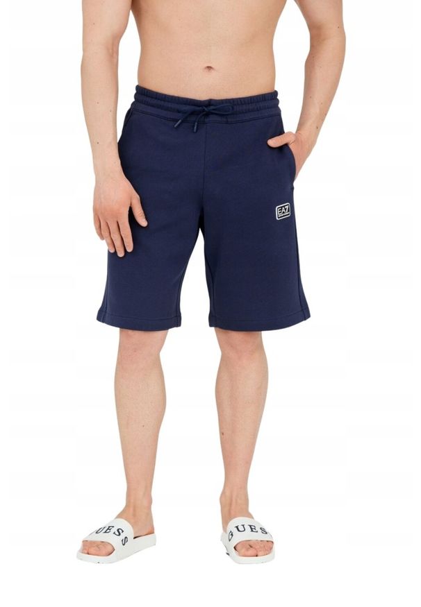 EA7 Emporio Armani - EA7 Męskie granatowe shorty z naszywką. Kolor: niebieski. Materiał: bawełna. Długość: krótkie. Wzór: aplikacja