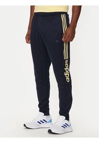 Adidas - adidas Spodnie dresowe Tiro Wordmark IW5997 Granatowy Regular Fit. Kolor: niebieski. Materiał: syntetyk #1