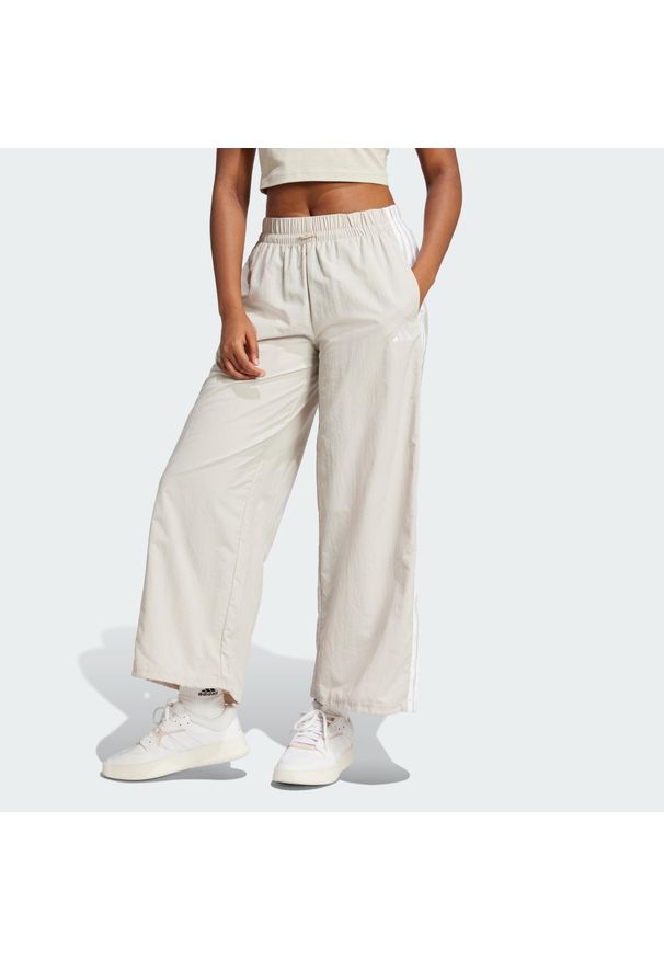 Adidas - Spodnie Essentials 3-Stripes Lifestyle Woven Parachute. Kolor: biały, beżowy, wielokolorowy. Materiał: materiał. Sport: fitness
