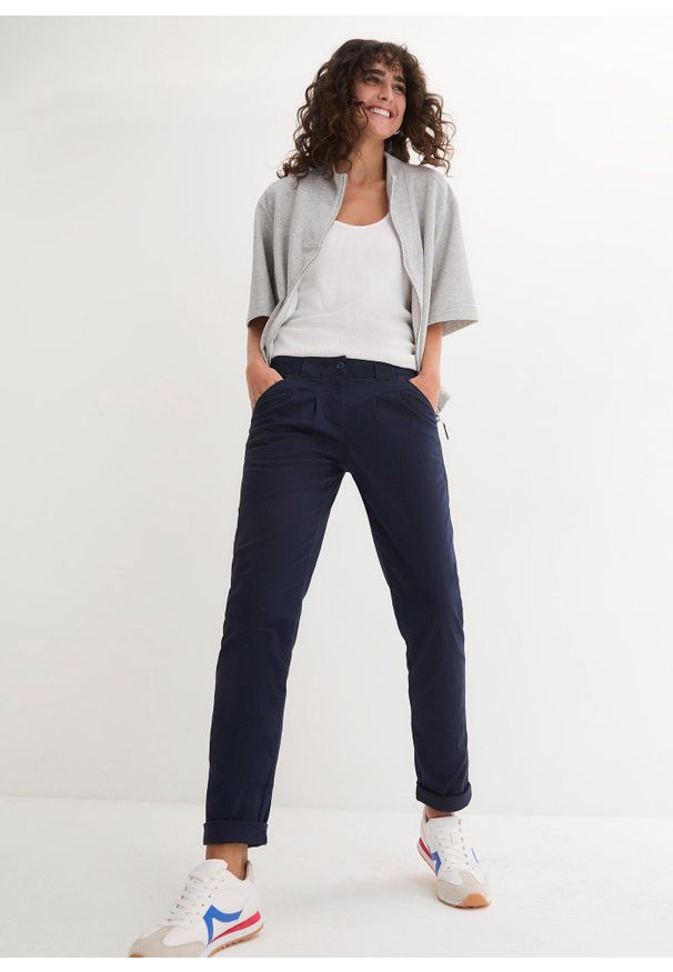 bonprix - Spodnie chino ze stretchem. Okazja: na co dzień. Stan: obniżony. Kolor: niebieski. Materiał: bawełna. Wzór: kwiaty. Styl: casual