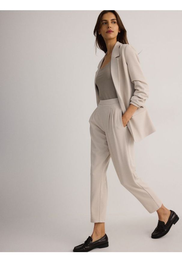 Reserved - Spodnie jogger z zakładkami - beżowy. Kolor: beżowy. Materiał: dzianina