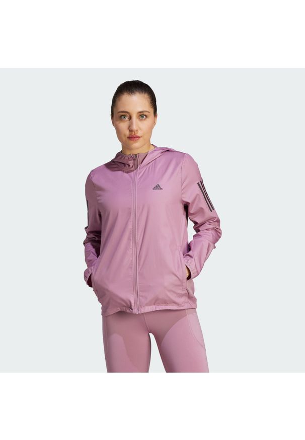 Adidas - Own the Run Hooded Running Windbreaker. Kolor: różowy. Materiał: materiał. Sport: bieganie