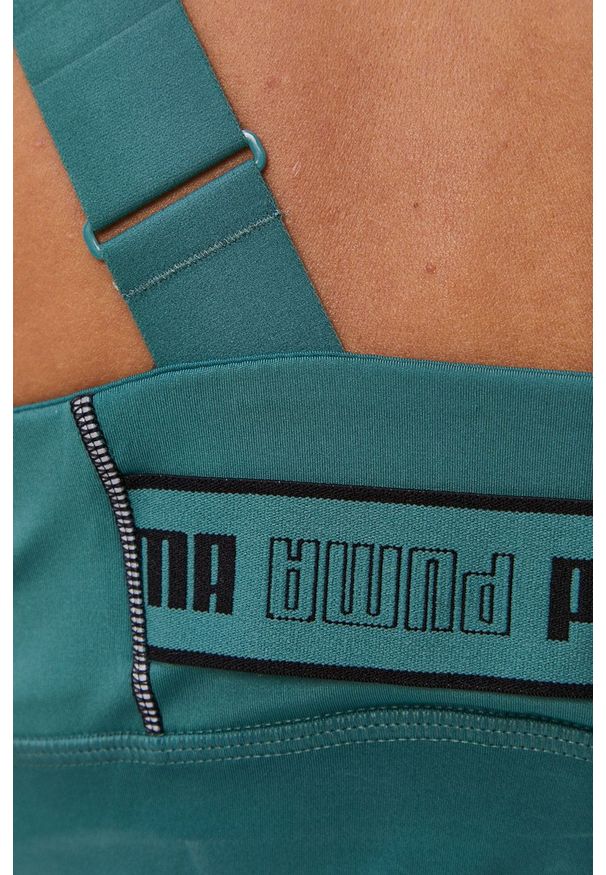 Puma - Biustonosz sportowy. Kolor: zielony. Rodzaj stanika: odpinane ramiączka, wyciągane miseczki