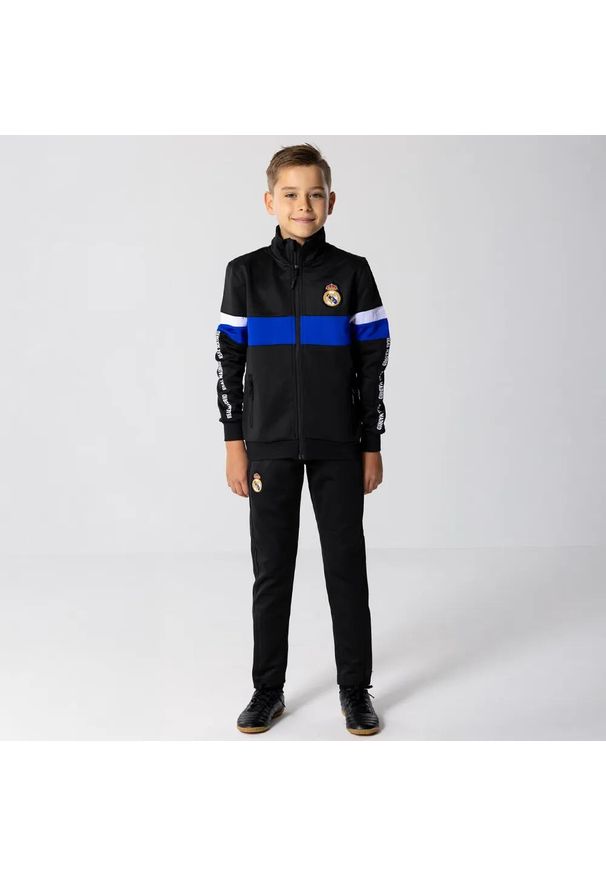 Dres piłkarski dziecięcy Real Madrid 24/25. Kolor: czarny. Materiał: dresówka. Styl: młodzieżowy, sportowy