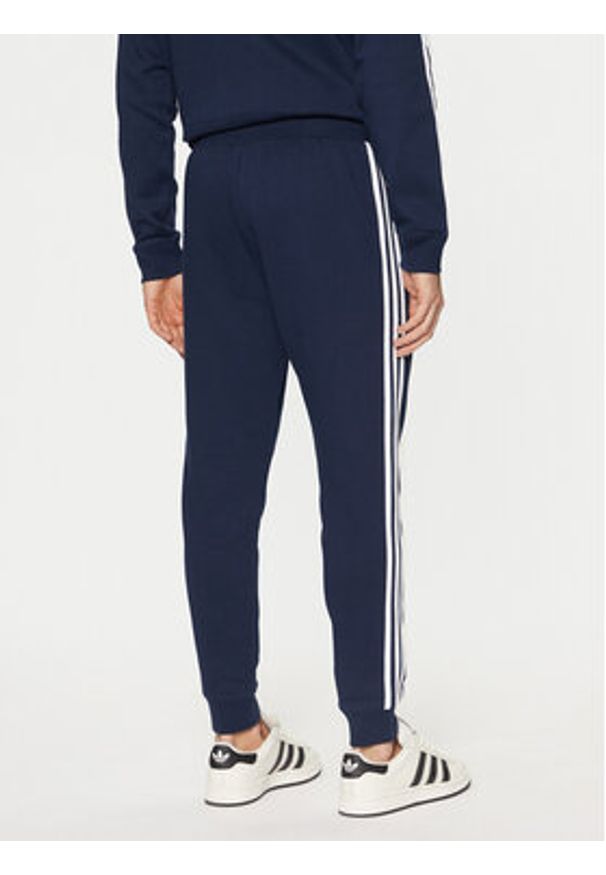 Adidas - adidas Spodnie dresowe adicolor 3-Stripes IM9319 Granatowy Slim Fit. Kolor: niebieski. Materiał: bawełna