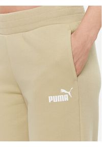 Puma Spodnie dresowe Ess+ 676093 Beżowy Regular Fit. Kolor: beżowy. Materiał: bawełna