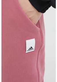 Adidas - adidas spodnie dresowe kolor pomarańczowy gładkie. Kolor: pomarańczowy. Materiał: dresówka. Wzór: gładki #4