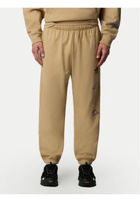The North Face Spodnie dresowe Unisex Mountain Cleanup NF0A8C2W Beżowy Relaxed Fit. Kolor: beżowy. Materiał: bawełna #1
