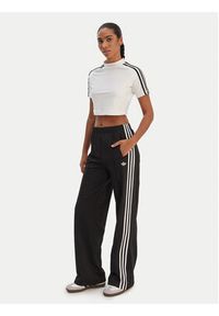 Adidas - adidas Spodnie dresowe Firebird KD7976 Czarny Loose Fit. Kolor: czarny. Materiał: syntetyk #3