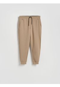 Reserved - Spodnie dresowe slim fit - beżowy. Kolor: beżowy. Materiał: dresówka