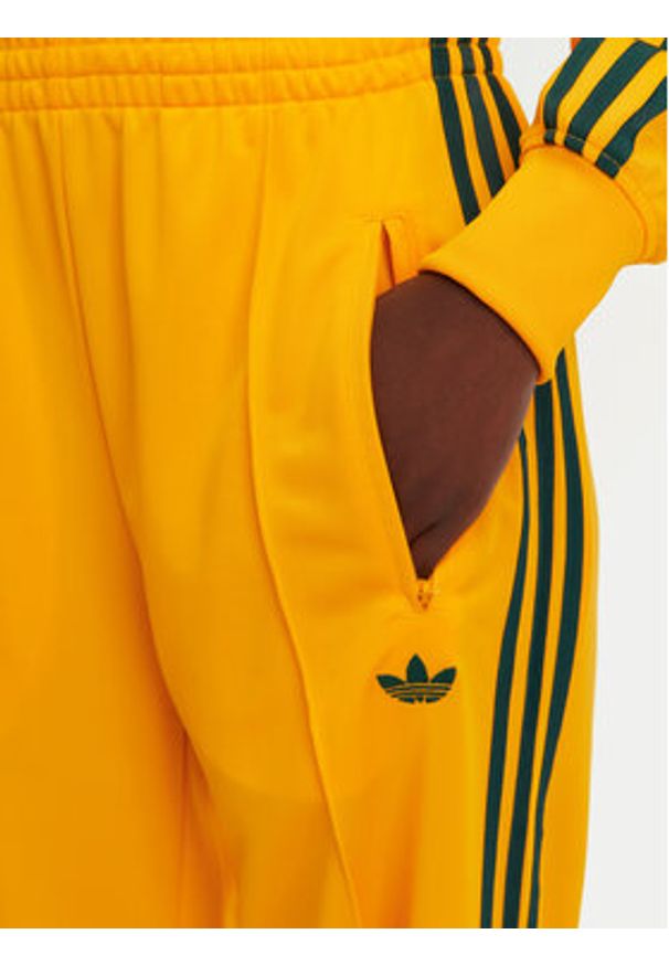 Adidas - adidas Spodnie dresowe adicolor Classic Firebird JP2316 Żółty Loose Fit. Kolor: żółty. Materiał: syntetyk