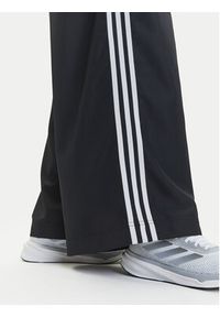 Adidas - adidas Spodnie dresowe adicolor Firebird JD3390 Czarny Loose Fit. Kolor: czarny. Materiał: syntetyk #5