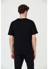 BALMAIN Czarny t-shirt z białym logo Retro Balmain Flock. Kolor: czarny. Styl: retro