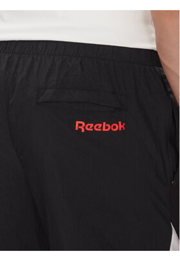 Reebok Spodnie dresowe 100223963 Czarny Regular Fit. Kolor: czarny. Materiał: syntetyk