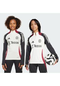 Adidas - Bluza Manchester United Tiro 24 Training Kids. Kolor: czarny, biały, wielokolorowy. Materiał: dresówka, materiał. Sport: piłka nożna