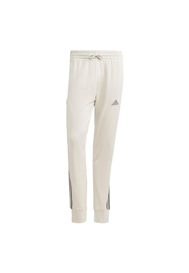 Adidas - Essentials French Terry Tapered Cuff 3-Stripes Pants. Kolor: zielony, wielokolorowy, szary. Materiał: dresówka