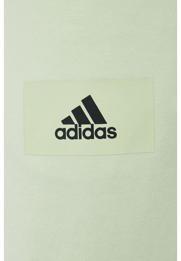 Adidas - adidas spodnie dresowe bawełniane męskie kolor zielony z nadrukiem. Kolor: zielony. Materiał: bawełna, dresówka. Wzór: nadruk