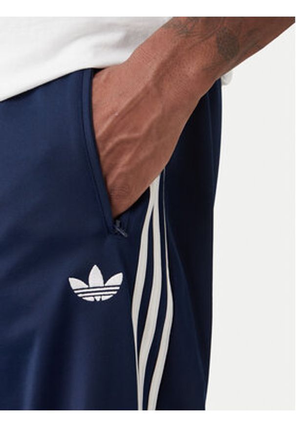 Adidas - adidas Spodnie dresowe Firebird KD8316 Granatowy Loose Fit. Kolor: niebieski. Materiał: syntetyk