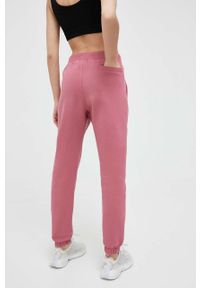 Adidas - adidas spodnie dresowe kolor pomarańczowy gładkie. Kolor: pomarańczowy. Materiał: dresówka. Wzór: gładki #2