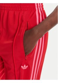 Adidas - adidas Spodnie dresowe adicolor Classic Firebird JW1225 Czerwony Loose Fit. Kolor: czerwony. Materiał: syntetyk