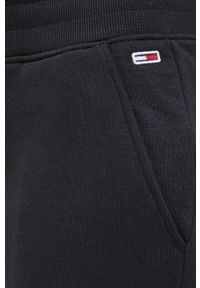 Tommy Jeans Spodnie damskie kolor czarny gładkie. Kolor: czarny. Materiał: dzianina. Wzór: gładki