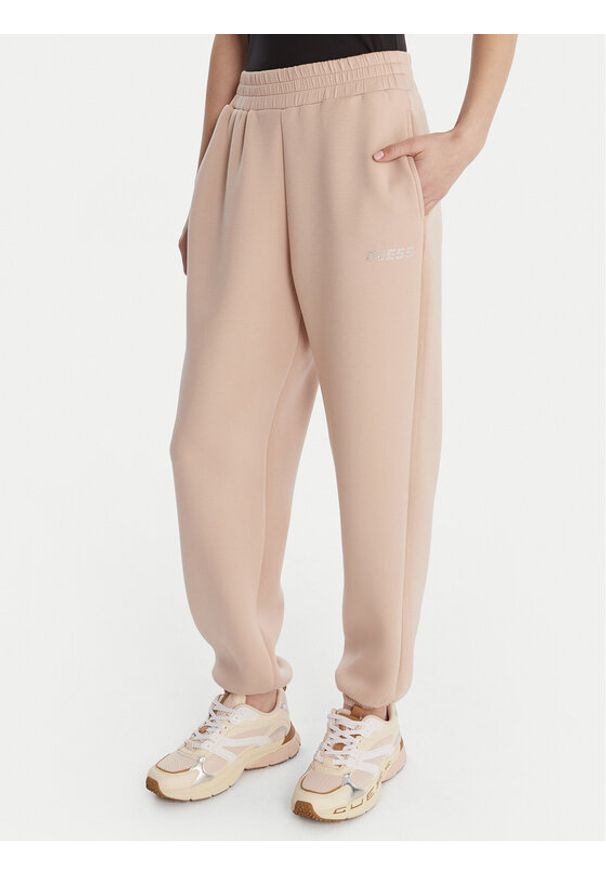 Guess Spodnie materiałowe 169841 Beżowy Slim Fit. Kolor: beżowy. Materiał: wiskoza