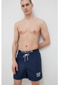 Calvin Klein szorty kąpielowe kolor granatowy. Kolor: niebieski. Materiał: tkanina, poliester, materiał. Wzór: nadruk
